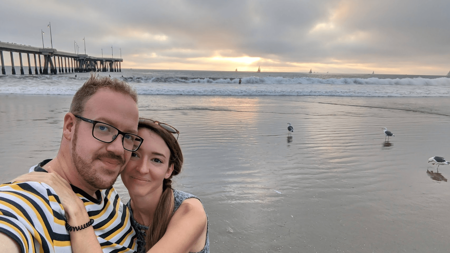 Matthew and Kiki at the beach at sunset